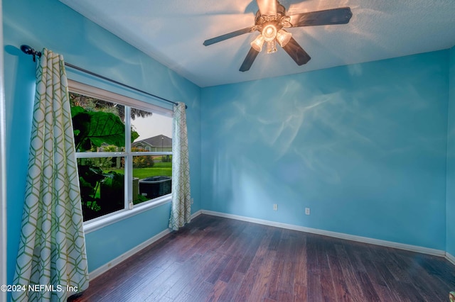 unfurnished room featuring a textured ceiling, ceiling fan, and dark hardwood / wood-style flooring