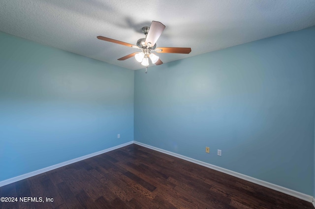 spare room featuring ceiling fan, a textured ceiling, and dark hardwood / wood-style flooring