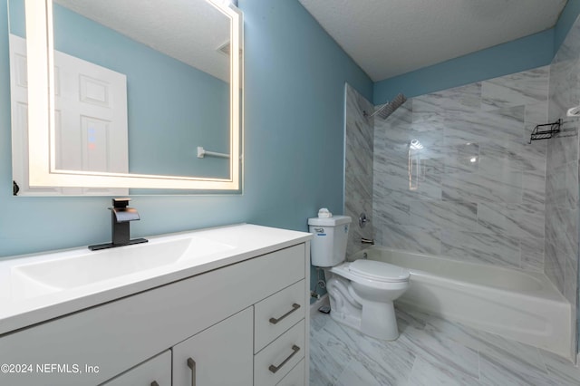 full bathroom featuring tiled shower / bath, vanity, toilet, and a textured ceiling