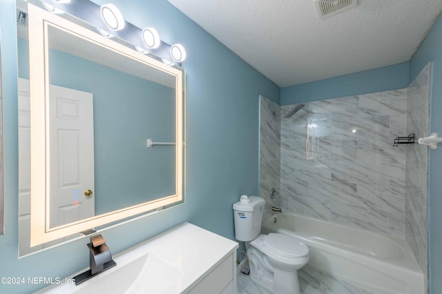 full bathroom with vanity, tiled shower / bath combo, toilet, and a textured ceiling