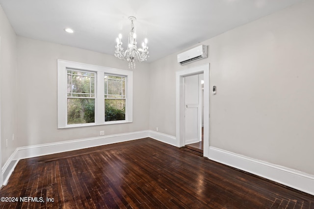 spare room featuring hardwood / wood-style flooring, recessed lighting, baseboards, and a wall mounted AC