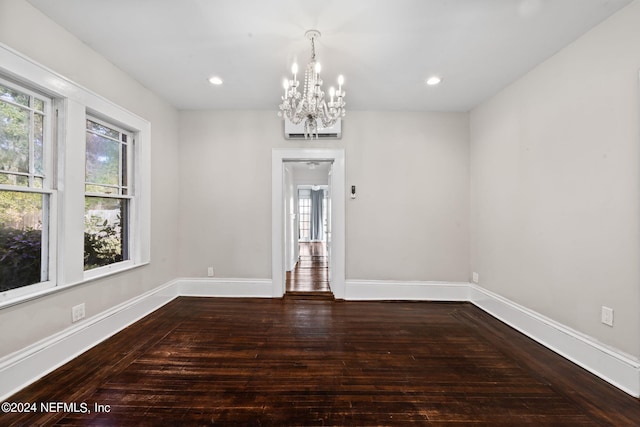 unfurnished room with an inviting chandelier, baseboards, hardwood / wood-style floors, and recessed lighting