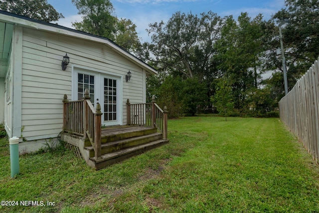 view of yard with fence and french doors