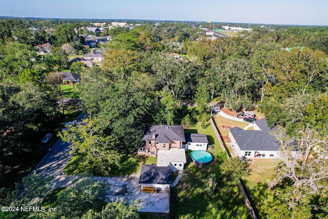 bird's eye view with a wooded view