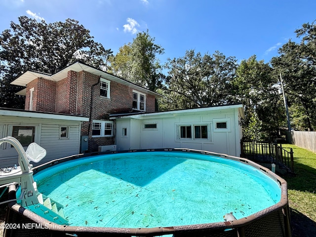 view of swimming pool featuring a fenced in pool and fence