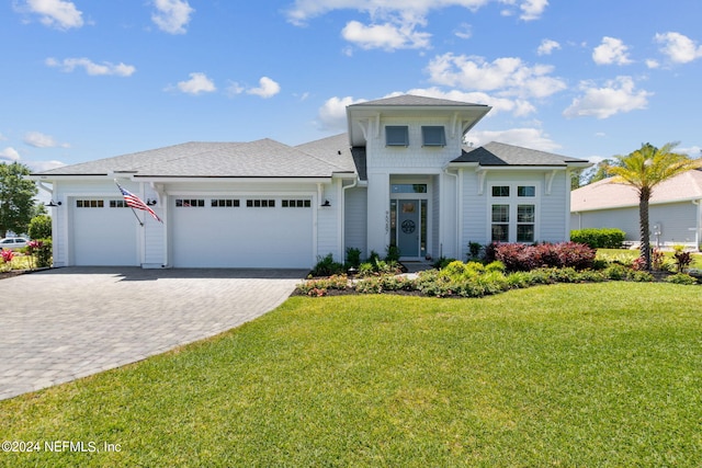 view of front facade with a front yard and a garage