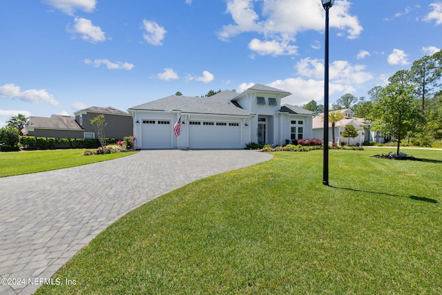 view of front facade featuring a front yard and a garage