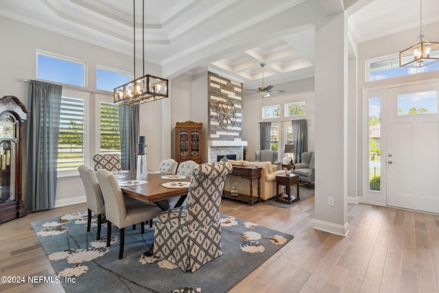 dining area featuring light hardwood / wood-style floors, ornamental molding, and a wealth of natural light