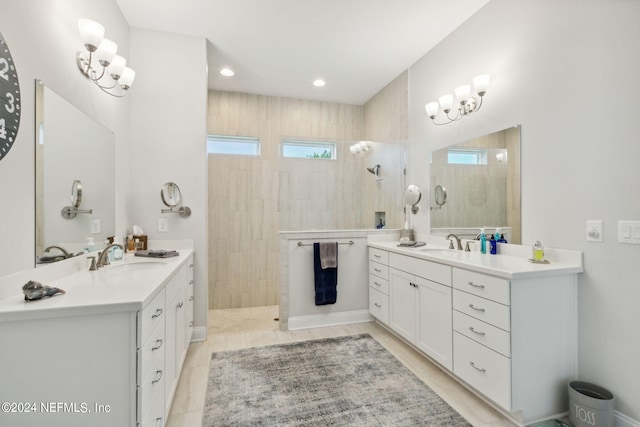 bathroom featuring a tile shower, tile patterned flooring, and vanity