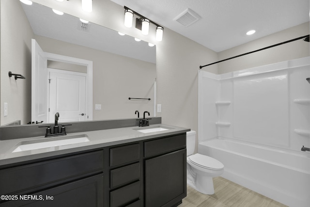 full bathroom featuring vanity, shower / bathtub combination, and toilet