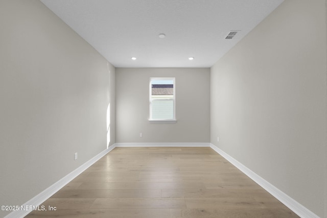 unfurnished room featuring light hardwood / wood-style flooring