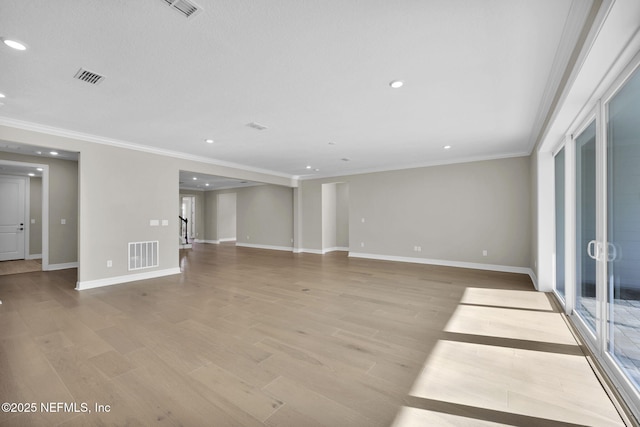 unfurnished living room with light hardwood / wood-style flooring and ornamental molding