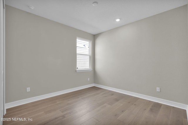 unfurnished room with light wood-type flooring