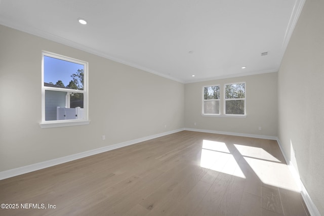 spare room with light hardwood / wood-style floors and ornamental molding