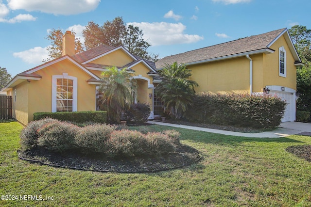 single story home with a front yard and a garage