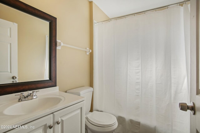 full bathroom with vanity, toilet, and shower / bath combination with curtain