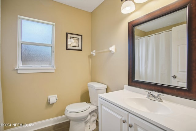 bathroom featuring toilet, hardwood / wood-style flooring, and vanity