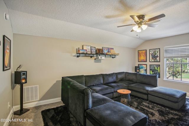 living room featuring ceiling fan, a textured ceiling, carpet, and vaulted ceiling