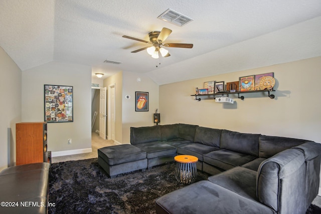 carpeted living room featuring a textured ceiling, ceiling fan, and vaulted ceiling