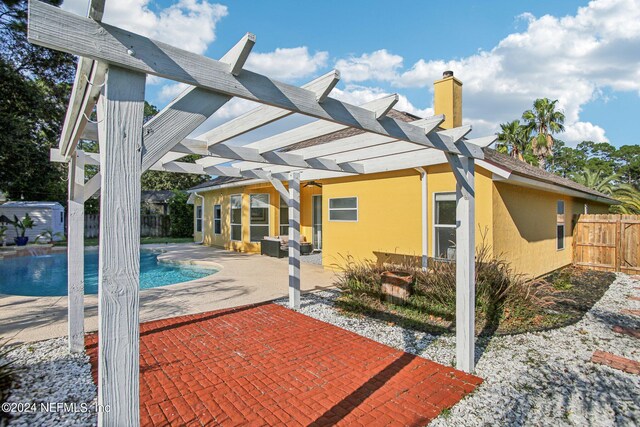 exterior space featuring a pergola and a fenced in pool