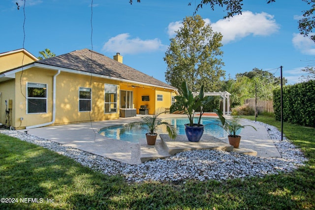 view of swimming pool with a pergola, a patio area, and a lawn