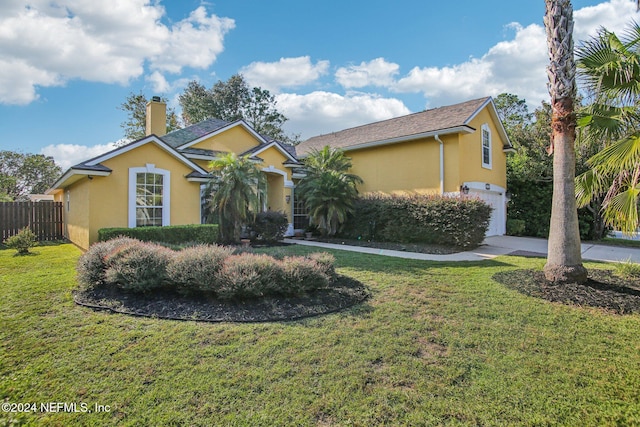 view of front of house with a front lawn and a garage