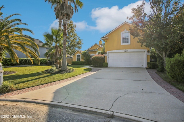 view of front of house with a front yard and a garage