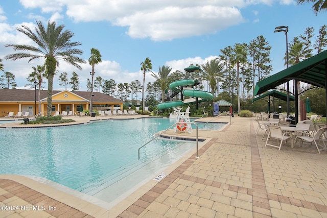 view of swimming pool featuring a patio and a water slide