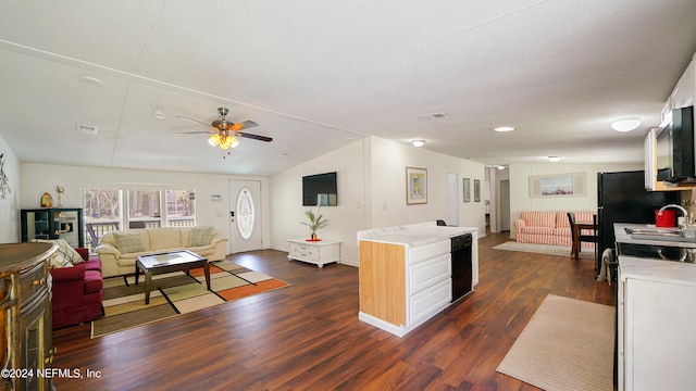 kitchen with ceiling fan, dark wood-type flooring, vaulted ceiling, sink, and white cabinets