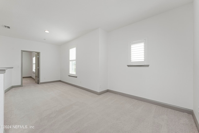 carpeted empty room with a wealth of natural light