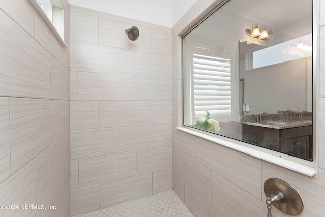 bathroom featuring vanity and tiled shower