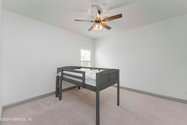 carpeted office featuring ceiling fan