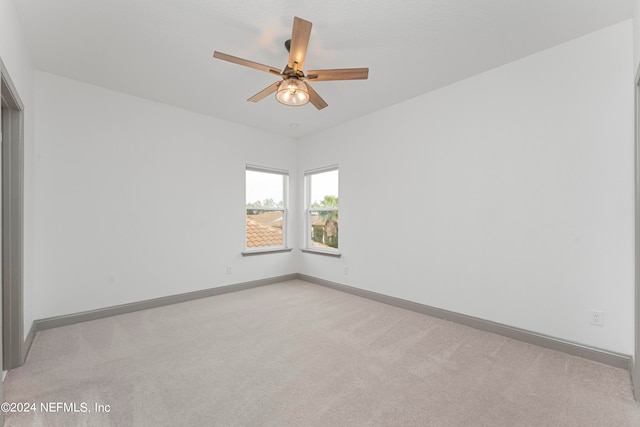 unfurnished room with light carpet and ceiling fan