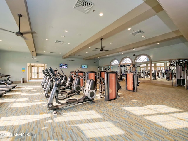 exercise room featuring ceiling fan and light carpet