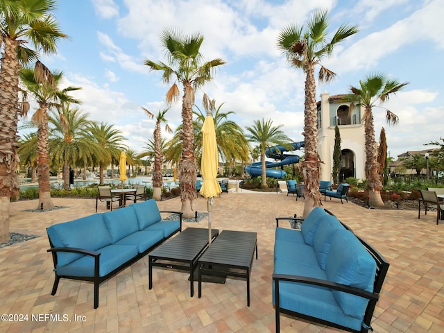 view of patio featuring an outdoor living space with a fireplace