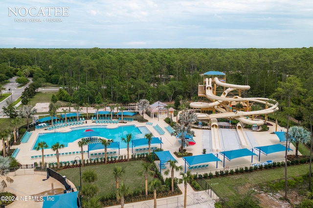 view of pool with a water slide and a patio area