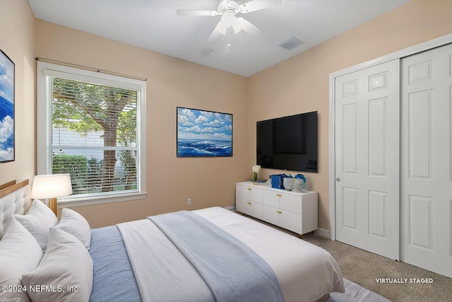 carpeted bedroom featuring a closet and ceiling fan