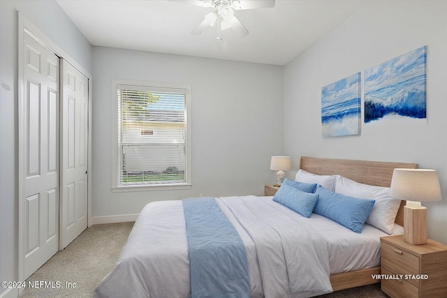 carpeted bedroom featuring a closet and ceiling fan