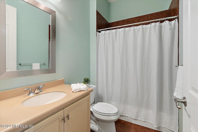 bathroom featuring vanity, a shower with curtain, toilet, and tile patterned floors