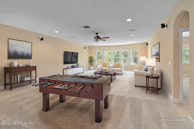 playroom with light carpet and ceiling fan