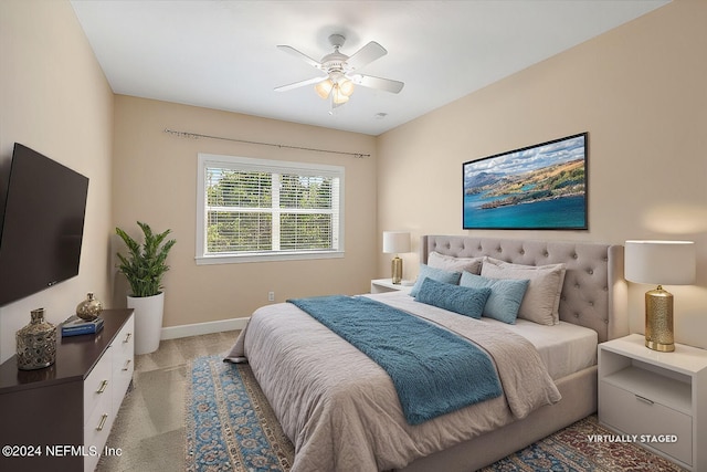 bedroom featuring light carpet and ceiling fan