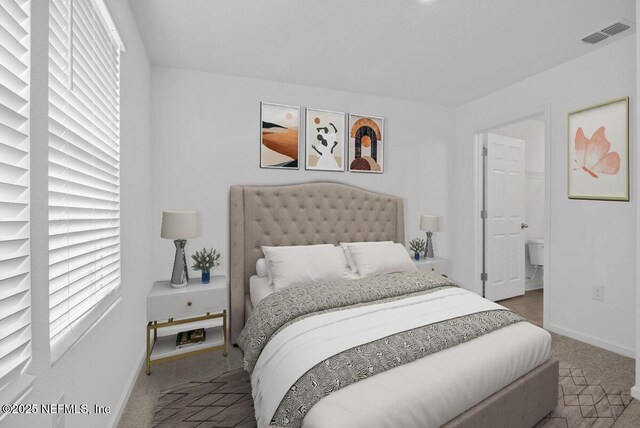 bedroom featuring multiple windows and carpet