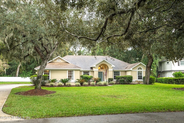 ranch-style home featuring a front yard