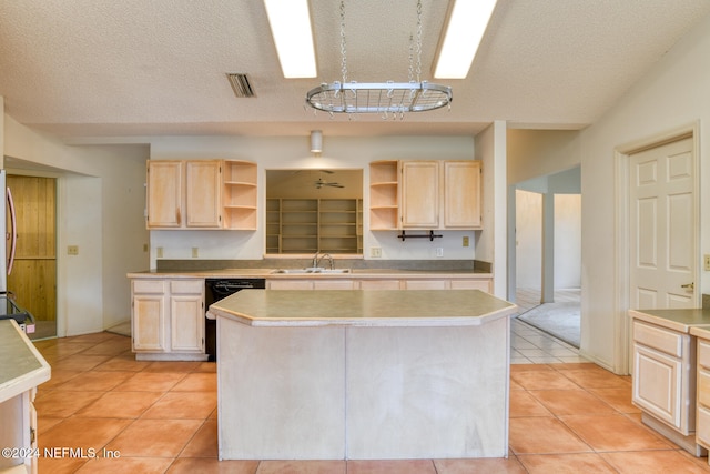 kitchen with light brown cabinets, dishwasher, light tile patterned floors, and a center island