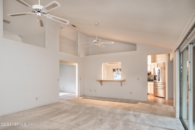 unfurnished living room with light carpet, a textured ceiling, high vaulted ceiling, and ceiling fan