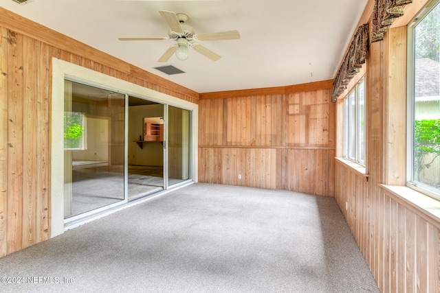 unfurnished sunroom with ceiling fan