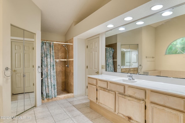 bathroom featuring tile patterned flooring, lofted ceiling, a shower with shower curtain, vanity, and a textured ceiling