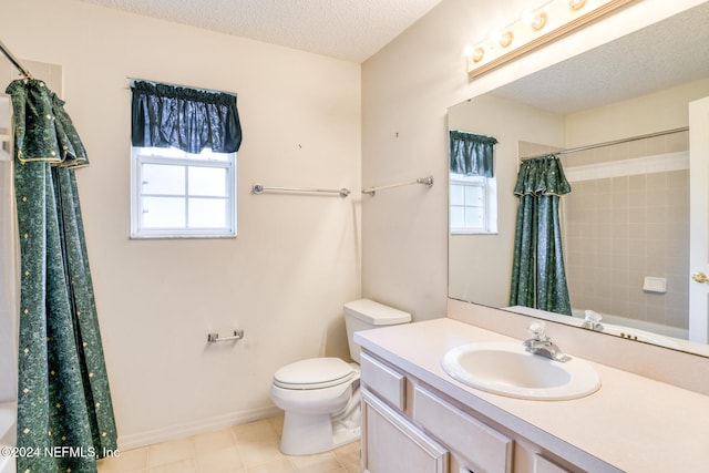 full bathroom with a textured ceiling, a wealth of natural light, toilet, and vanity