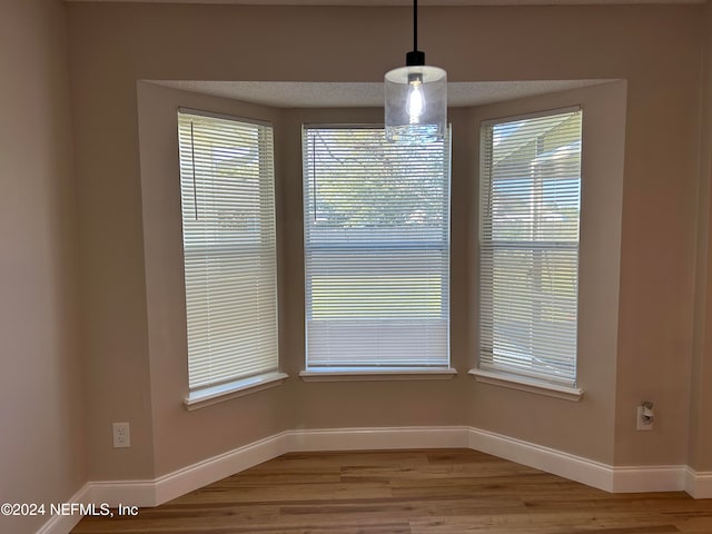 interior details with a textured ceiling and hardwood / wood-style flooring