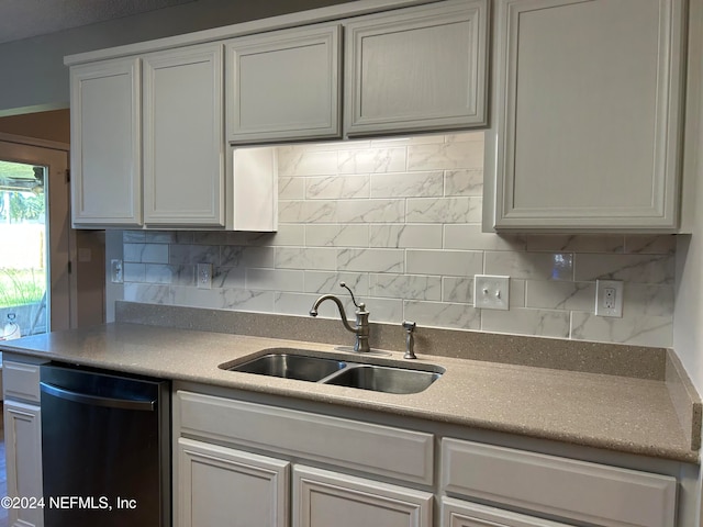 kitchen featuring dishwasher, backsplash, and sink